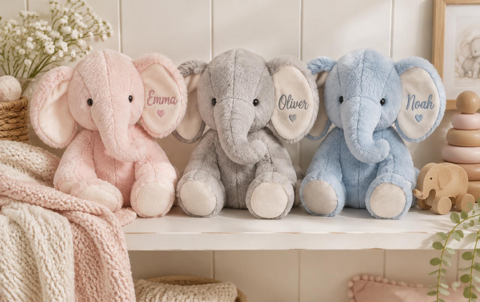 Pink, grey and blue personalized elephant stuffies on a nursery shelf